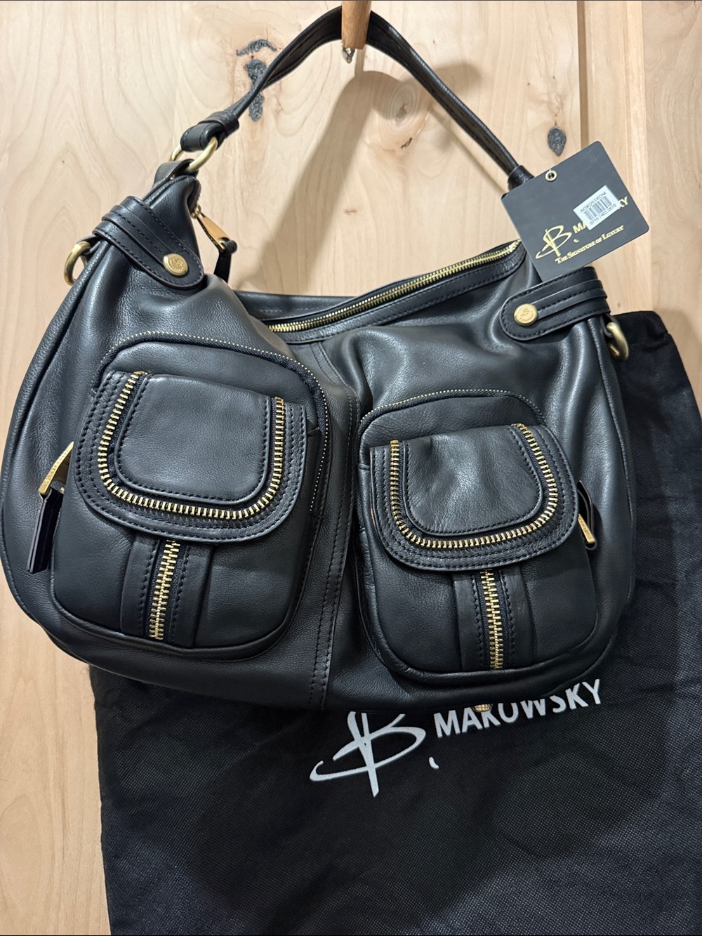 b. makowsky Black Leather Shoulder Bag with Front Zip Pockets and Gold Hardware